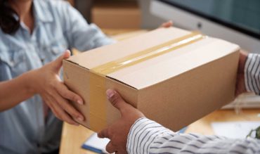 giving-parcel-to-courier-E9PNCYB.jpg